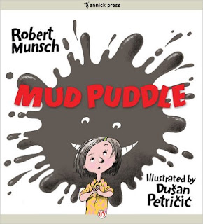 Book cover of Mud Puddle by Robert Munsch, illustrated by Dušan Petričić, with a girl in a splash of mud