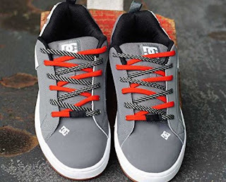 Gray sneakers with red and black elastic no-tie laces