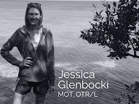 Jessica Glenbocki, MOT, OTR/L, standing by the water in a black and white portrait