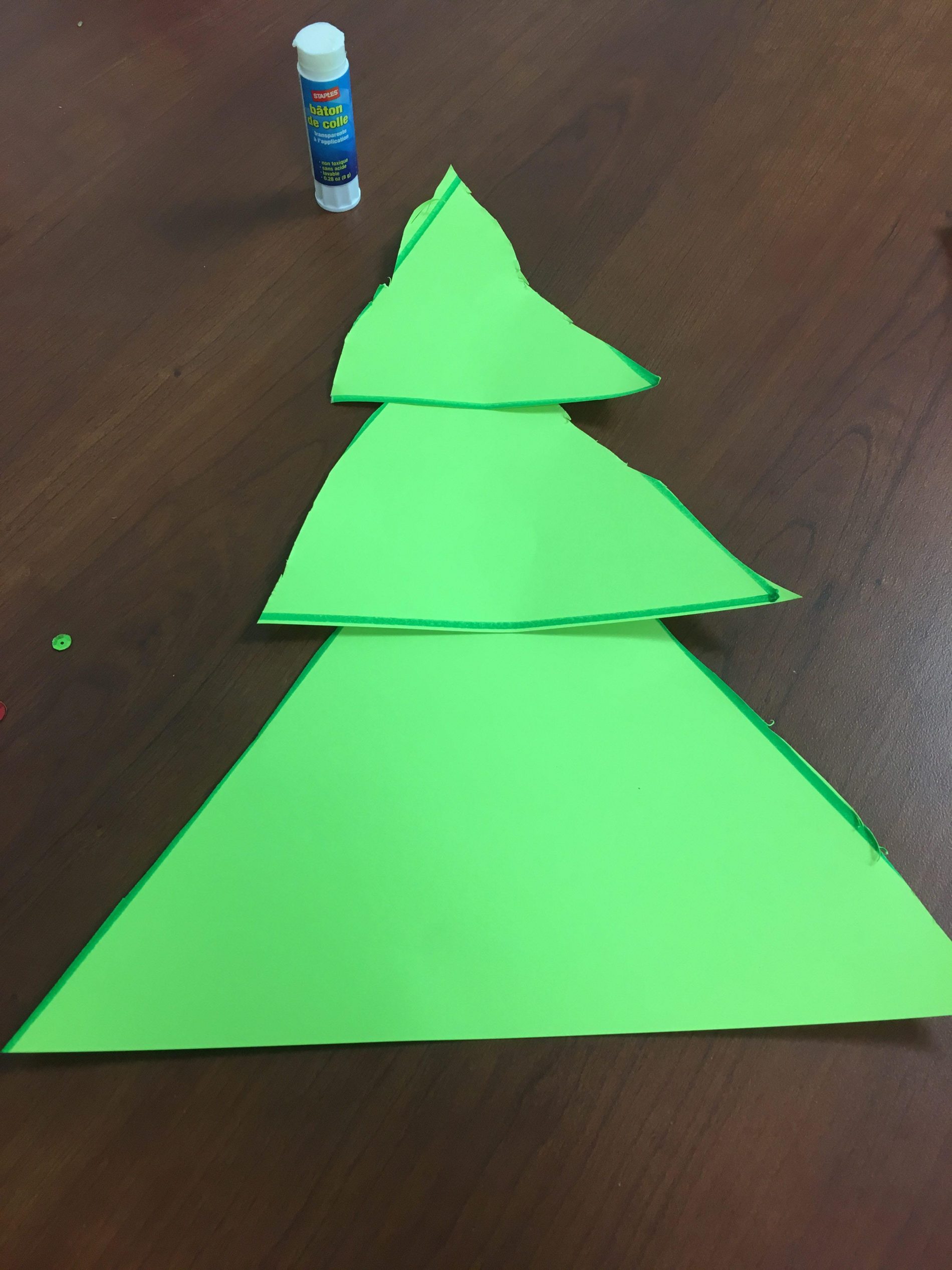 Green paper Christmas tree made from three glued triangles