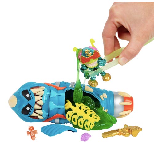 Hand using tongs to lift slime from a toy alien dissection kit