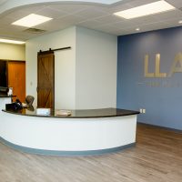 Reception desk and waiting area in an LLA Therapy office lobby